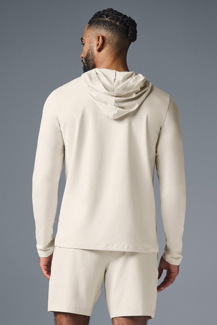 ALO YOGA CONQUER REFORM LONG SLEEVE WITH HOOD - BONE