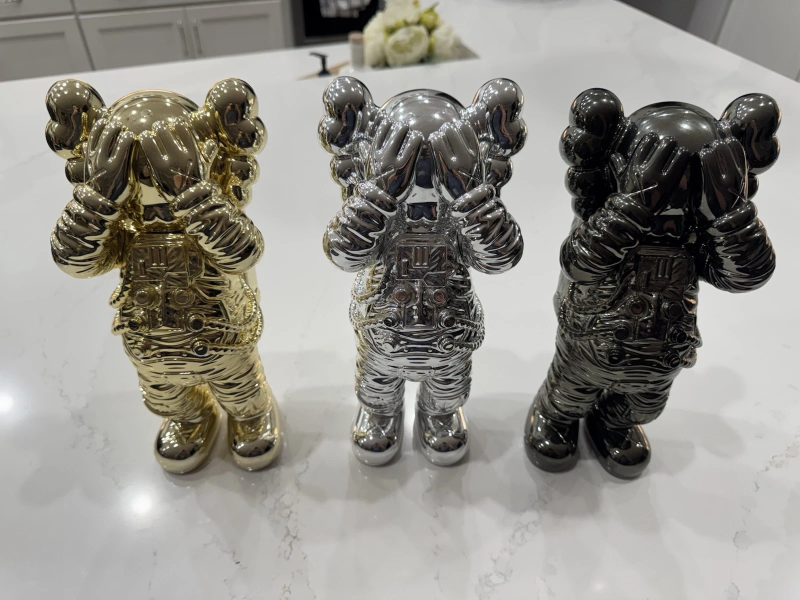 KAWS HOLIDAY SPACE FIGURE SET (GOLD SILVER & BLACK)- COMPLETE SET OF 4 FIGURES