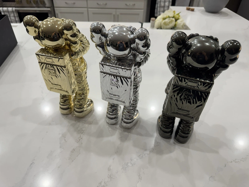 KAWS HOLIDAY SPACE FIGURE SET (GOLD SILVER & BLACK)- COMPLETE SET OF 4 FIGURES